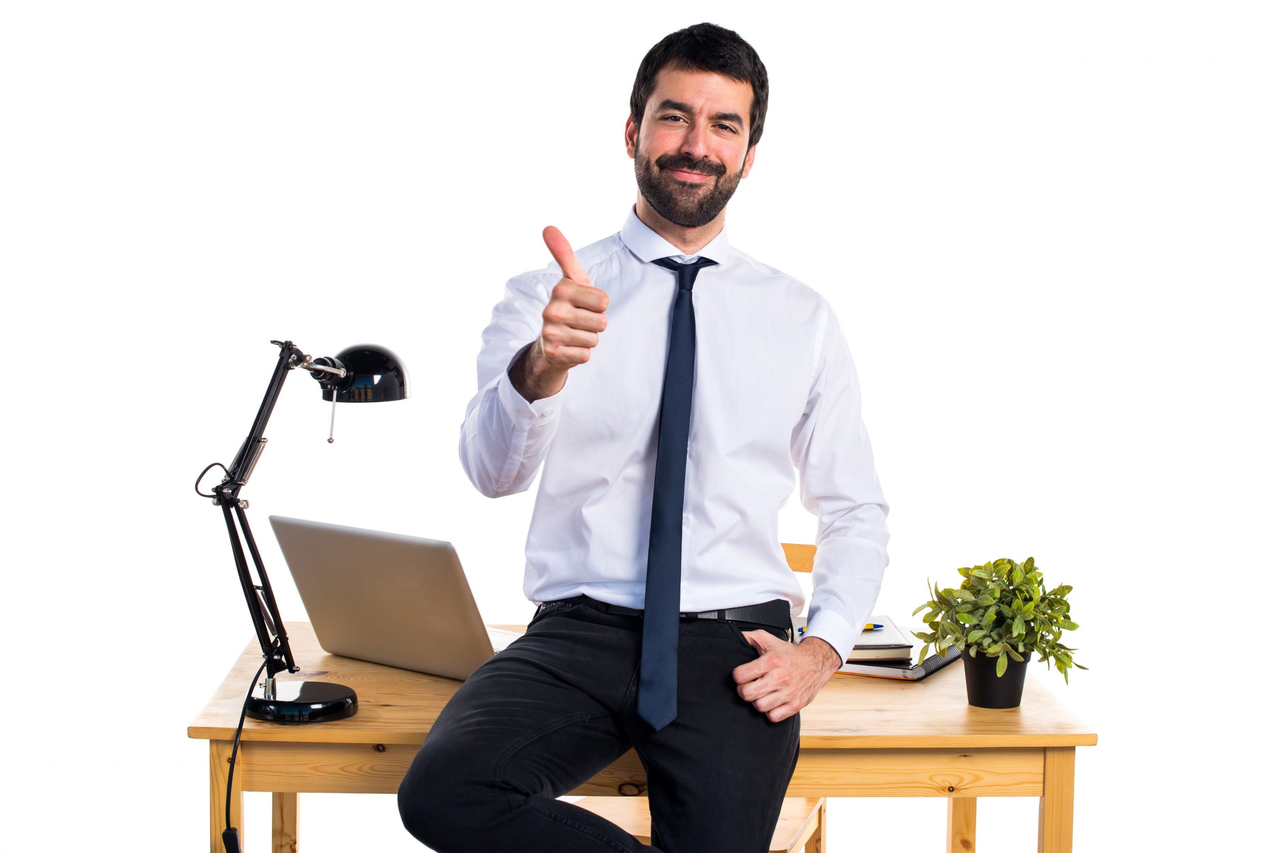 Businessman in his office with thumb up Businessman in his office with thumb up
